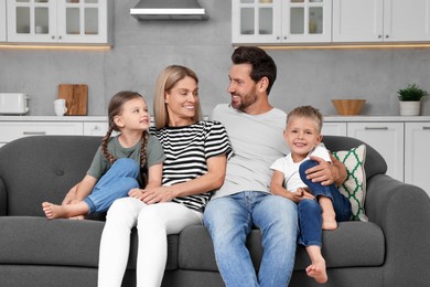 Photo of Happy family spending time together on sofa at home