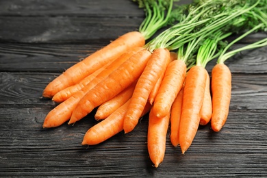 Ripe carrots on wooden background. Healthy diet