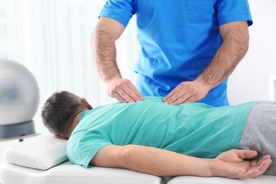 Photo of Doctor working with patient in hospital. Rehabilitation massage