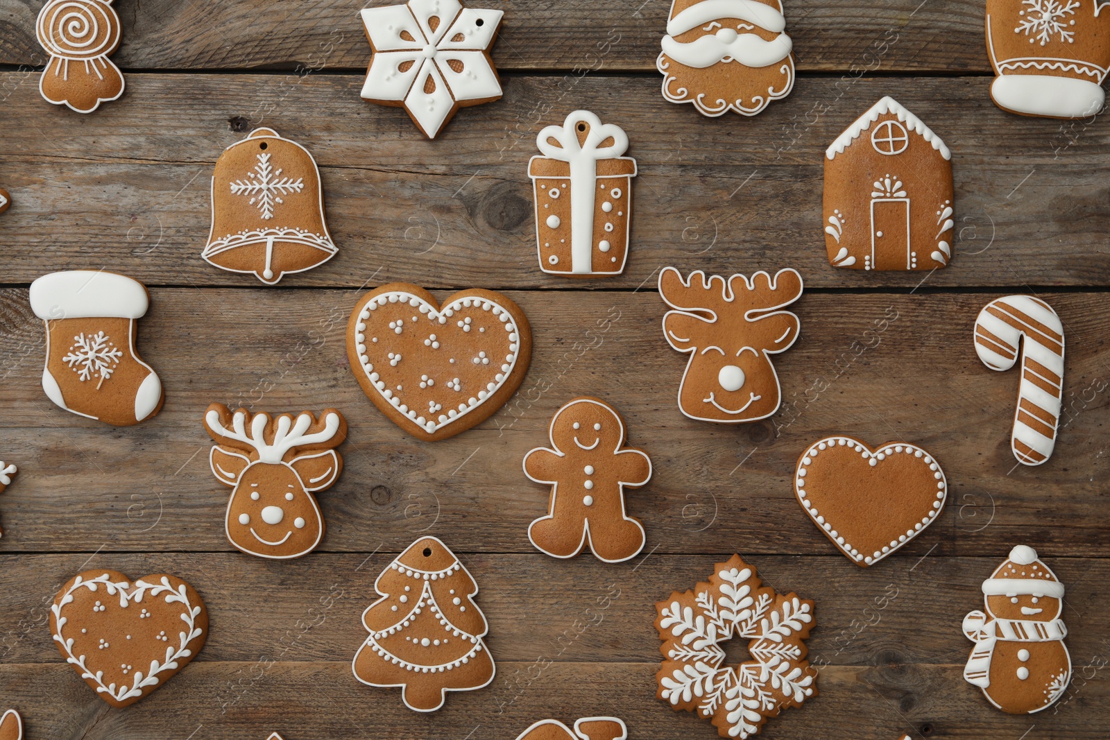 Photo of Many different delicious Christmas cookies on wooden table, flat lay