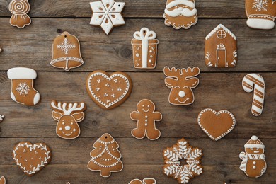 Many different delicious Christmas cookies on wooden table, flat lay