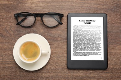 Portable e-book reader, cup of coffee and glasses on wooden table, flat lay