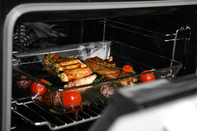 Photo of Delicious roasted ribs in oven. Yummy meat