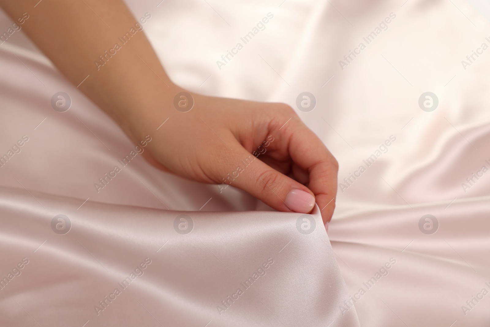 Photo of Woman touching smooth silky fabric, closeup view