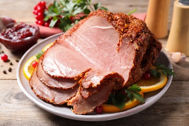 Delicious ham served with garnish on wooden table