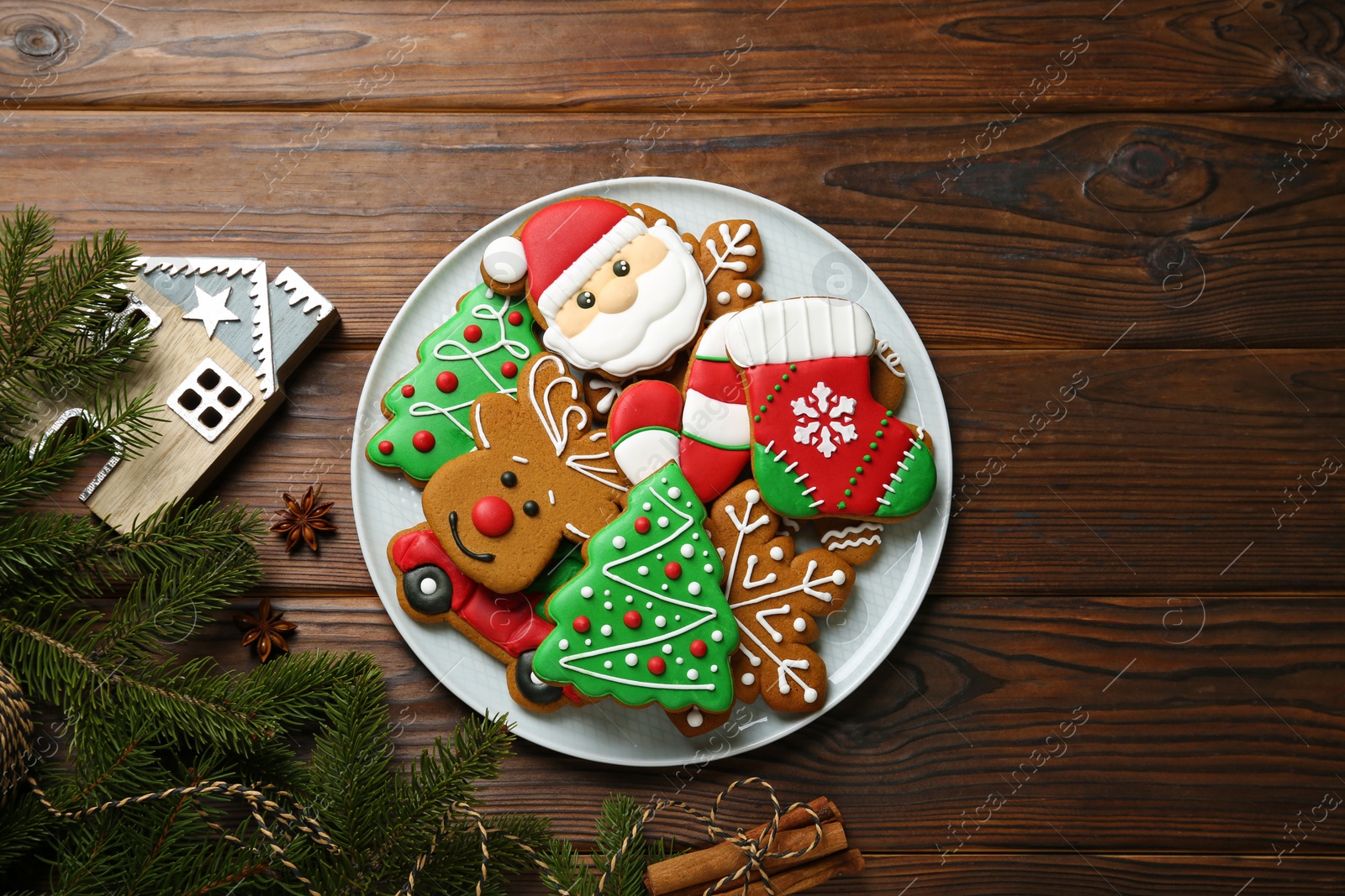Photo of Different tasty Christmas cookies and festive decor on wooden table, flat lay. Space for text
