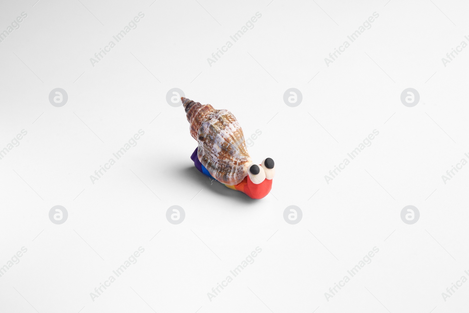 Photo of Beautiful plasticine snail isolated on white. Children's handmade ideas