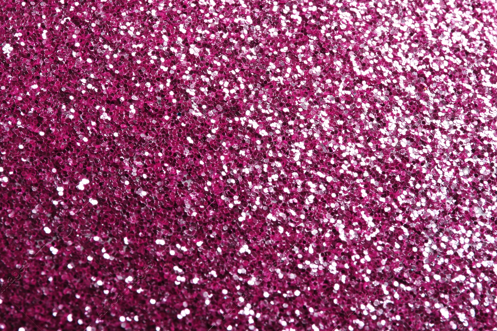 Photo of Closeup view of sparkling pink glitter background