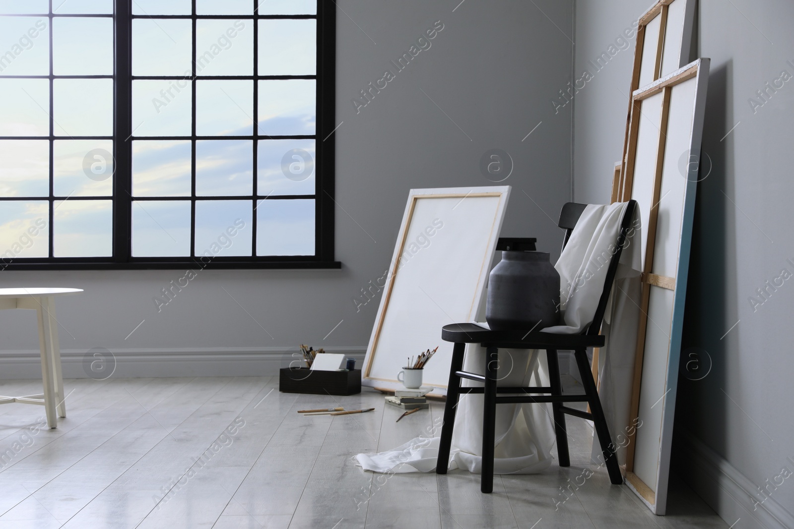 Photo of Stylish artist's studio interior with canvas and brushes