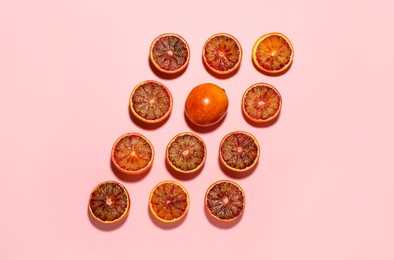 Photo of Many ripe sicilian oranges on pink background, flat lay