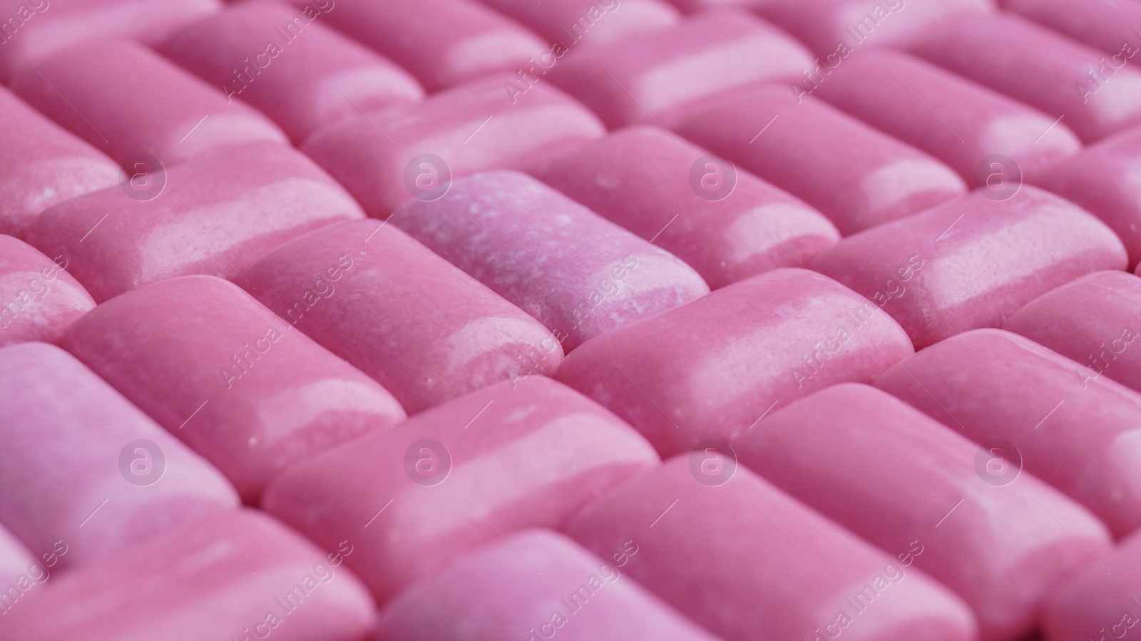 Photo of Many pink chewing gums as background, closeup