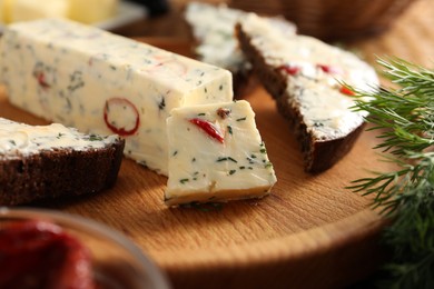 Photo of Tasty butter with dill, chili pepper and rye bread on table, closeup