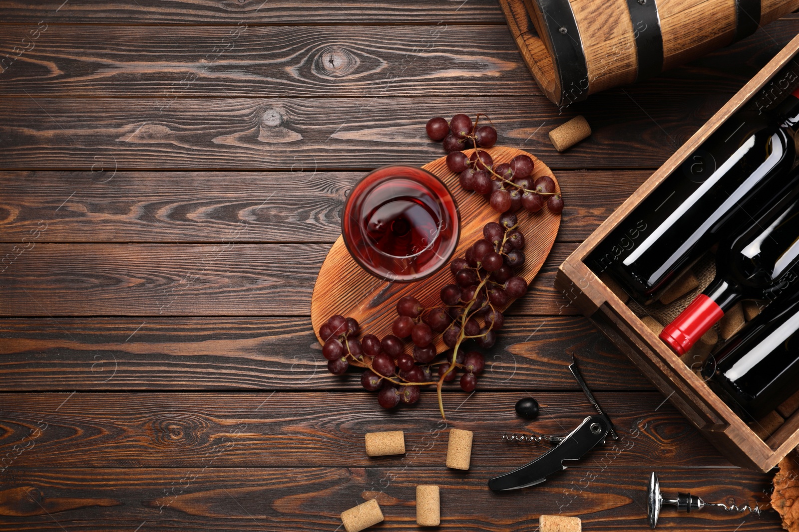 Photo of Winemaking. Flat lay composition with tasty wine and barrel on wooden table, space for text