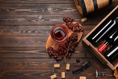 Winemaking. Flat lay composition with tasty wine and barrel on wooden table, space for text