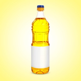 Image of Cooking oil in plastic bottle with empty label on light yellow background. Mockup for design