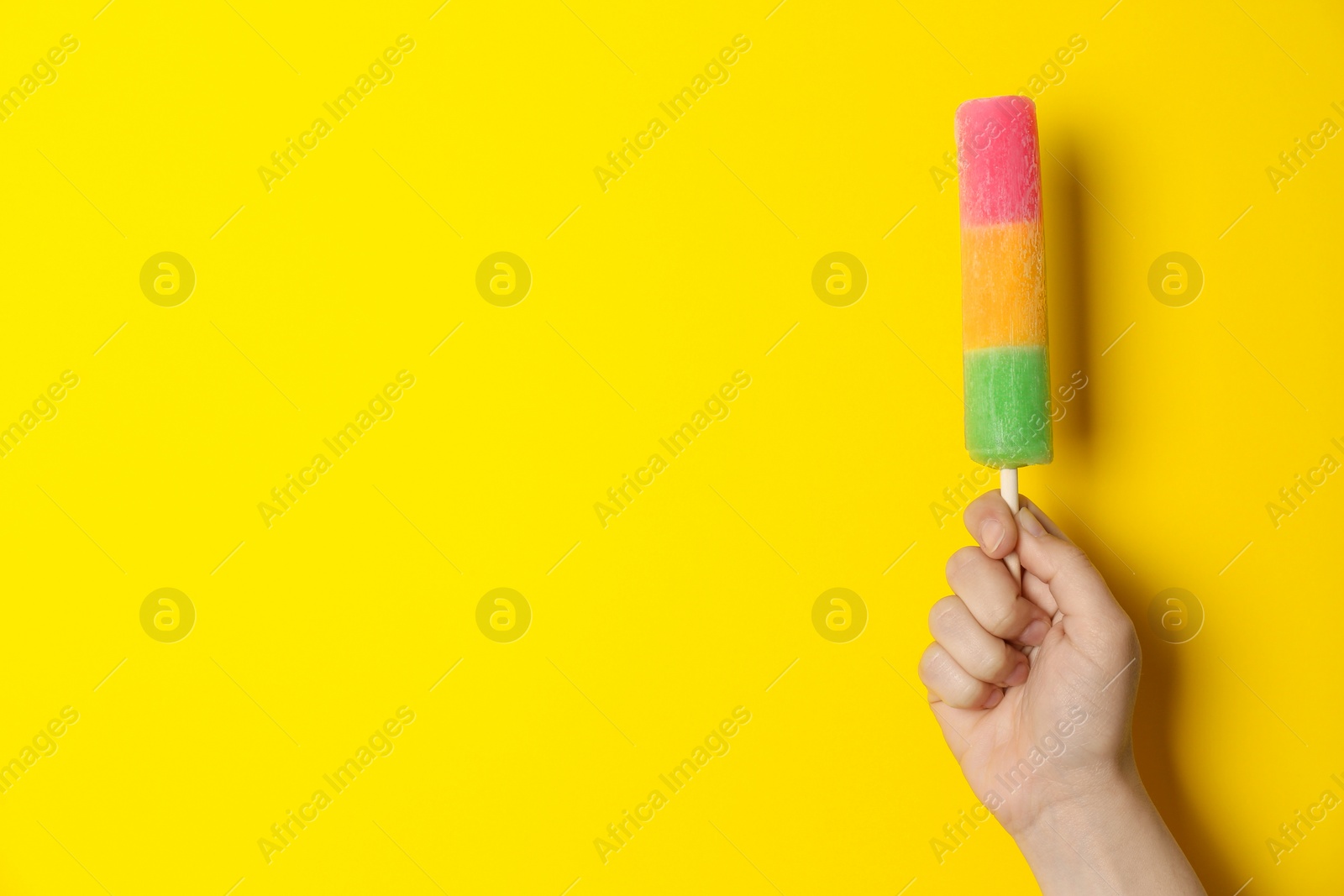 Photo of Woman holding delicious ice cream against color background, space for text