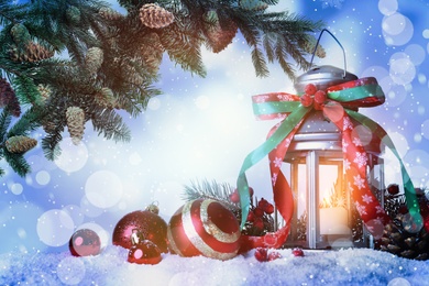 Image of Beautiful composition with vintage Christmas lantern and festive decorations on snow against color background. Bokeh effect