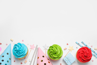 Flat lay composition with colorful birthday cupcakes on white background. Space for text