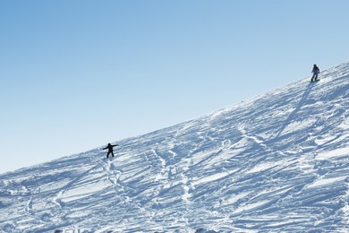 Photo of Male skiers on slope at resort. Winter vacation