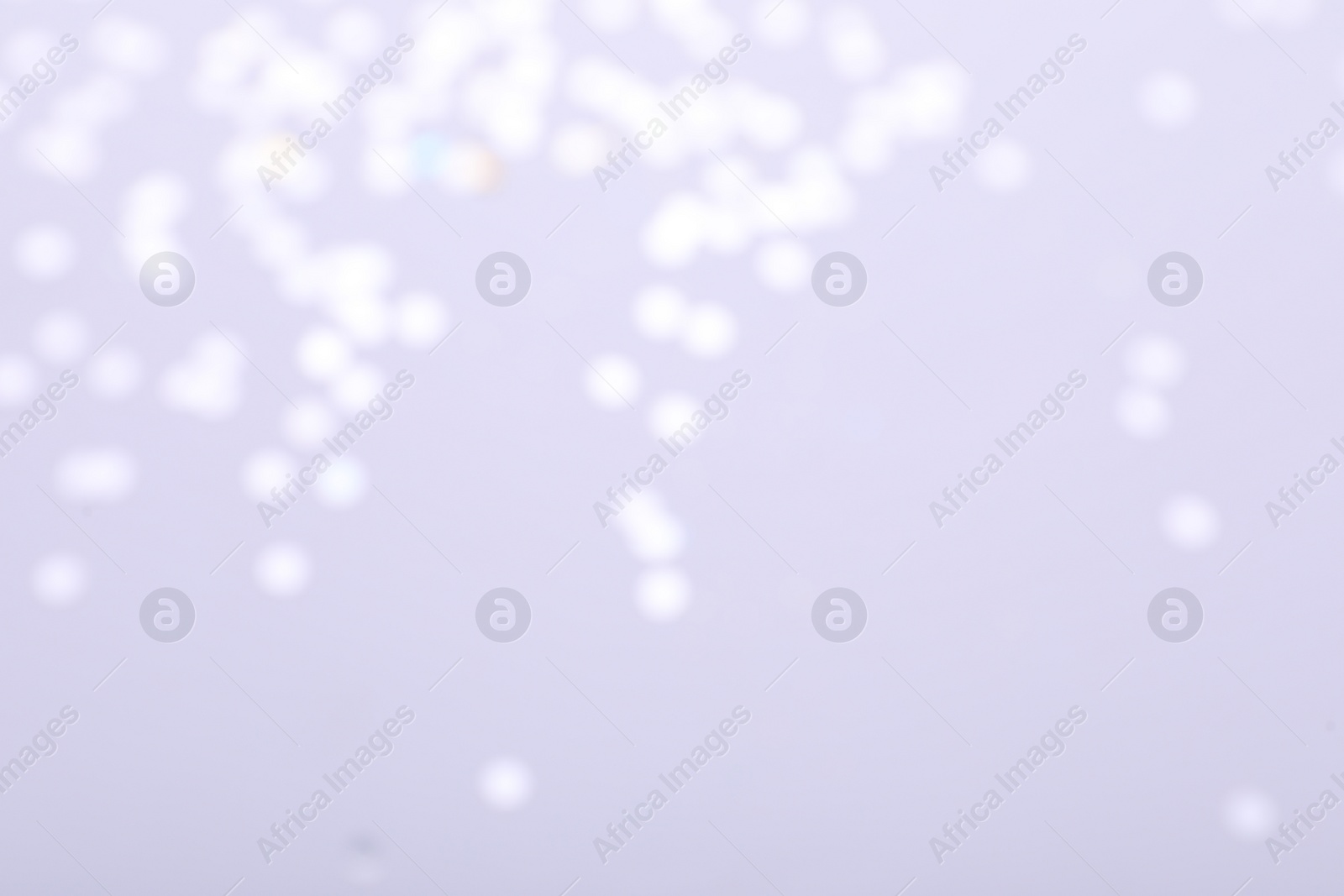 Photo of Blurred view of festive lights on light background. Bokeh effect