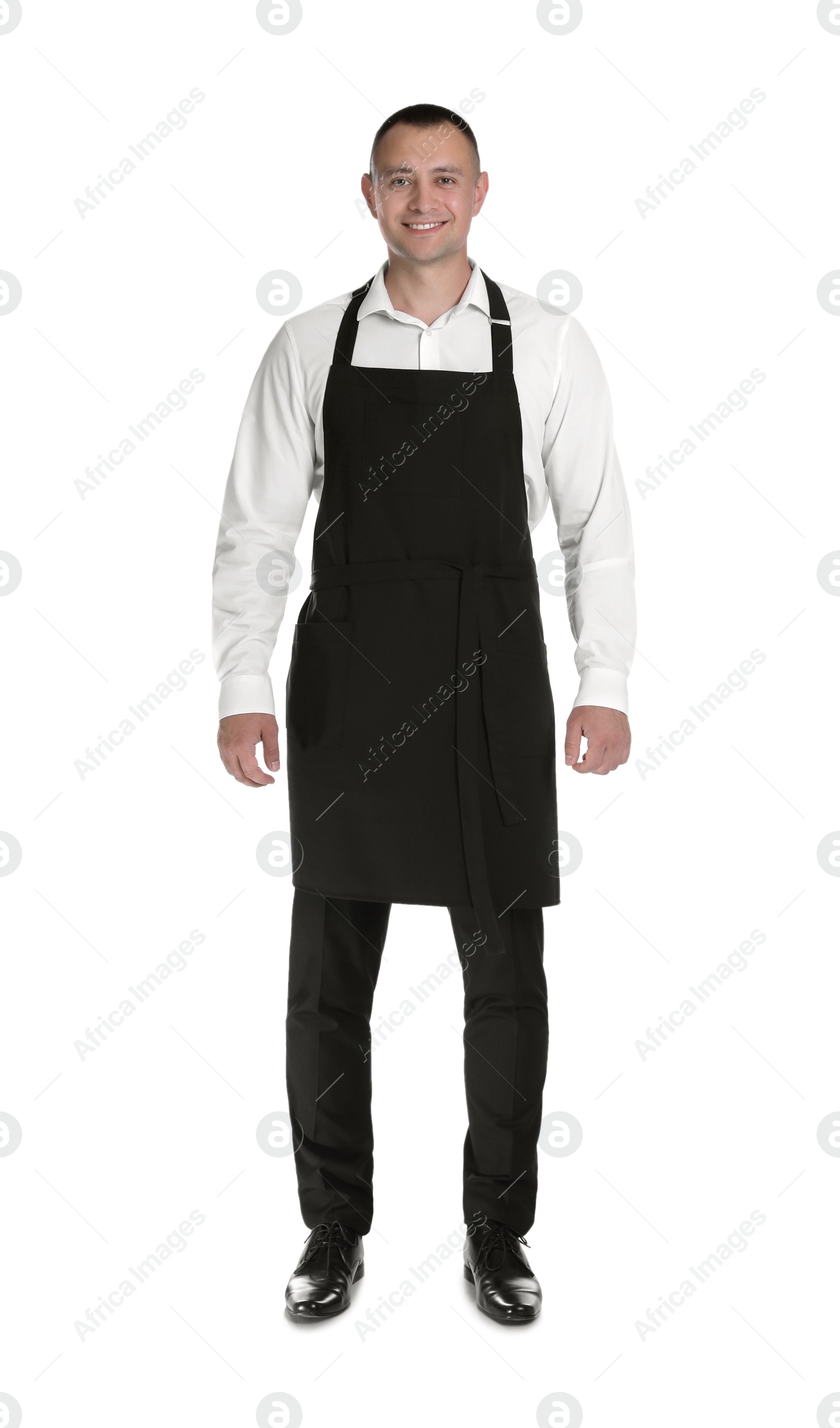 Photo of Full length portrait of happy young waiter in uniform on white background