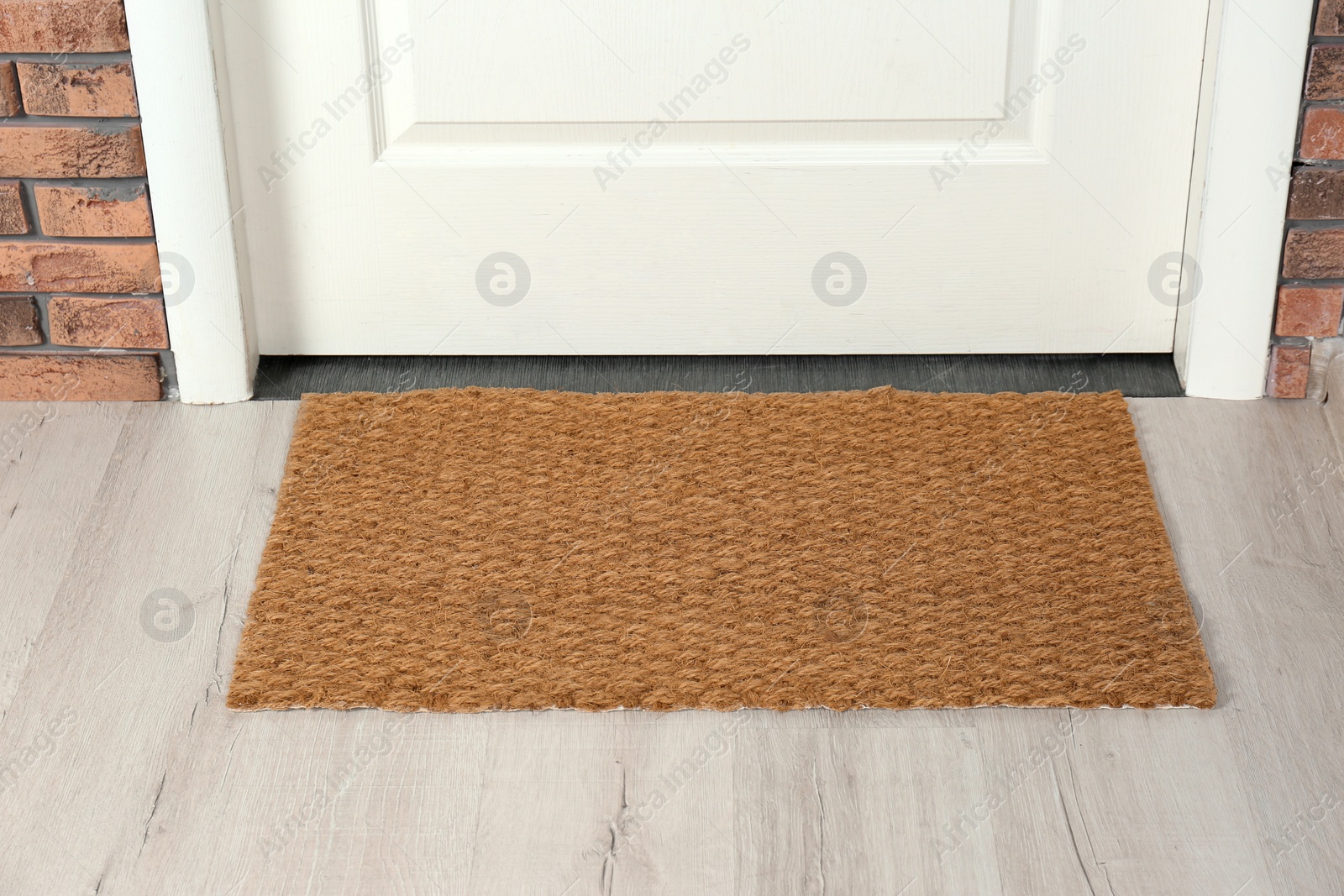 Photo of New clean mat near entrance door. Household item