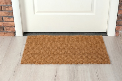 Photo of New clean mat near entrance door. Household item