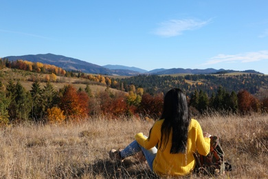 Photo of Female traveler viewing peaceful mountain landscape