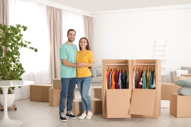 Young couple near wardrobe boxes at home