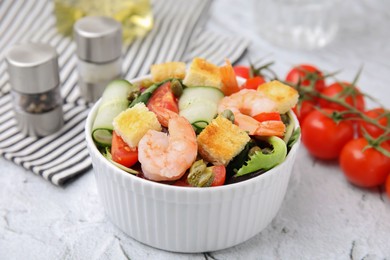 Photo of Tasty salad with croutons, tomato and capers on white textured table, closeup