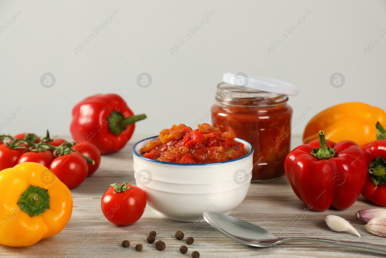 Photo of Tasty lecho and fresh ingredients on wooden table