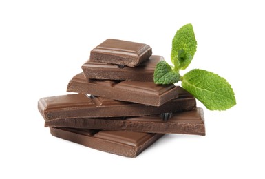 Tasty chocolate pieces and mint on white background