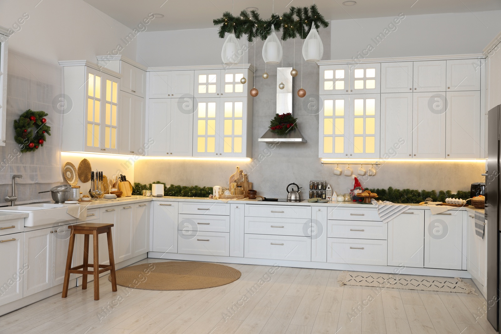 Photo of Cozy spacious kitchen decorated for Christmas. Interior design