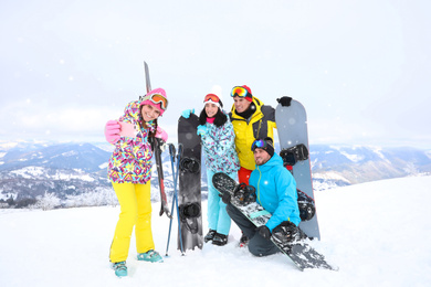 Photo of Group of friends taking selfie at mountain resort. Winter vacation