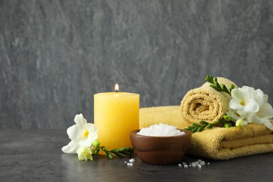 Photo of Composition with different spa products and burning candle on grey table