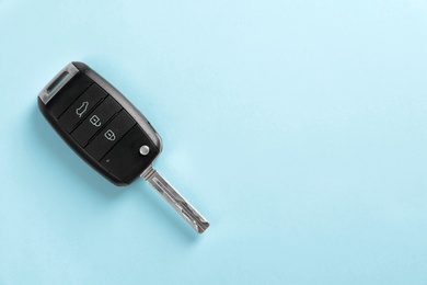 Car key on color background, top view with space for text