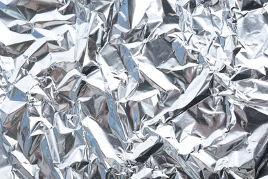 Crumpled silver foil as background, closeup view