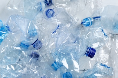 Many used plastic bottles as background, top view. Recycling problem