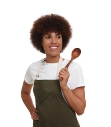 Happy young woman in apron holding wooden spoon on white background