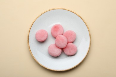 Photo of Plate with delicious mochi on beige background, top view. Traditional Japanese dessert