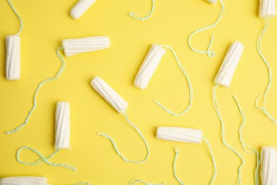 Tampons on yellow background, flat lay. Menstrual hygiene product