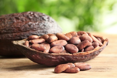 Cocoa pod with beans on wooden table