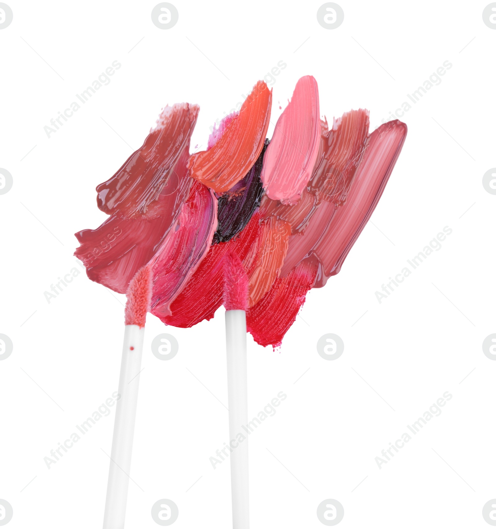 Photo of Strokes of different lip glosses and applicators isolated on white, top view