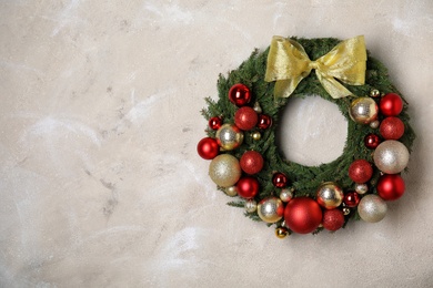 Photo of Beautiful Christmas wreath with festive decor on grey background. Space for text