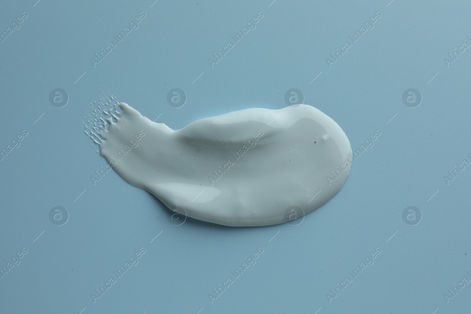 Photo of Sample of face mask on light blue background, top view