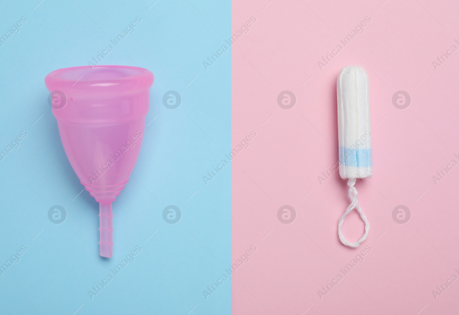 Photo of Menstrual cup and tampon on color background, flat lay