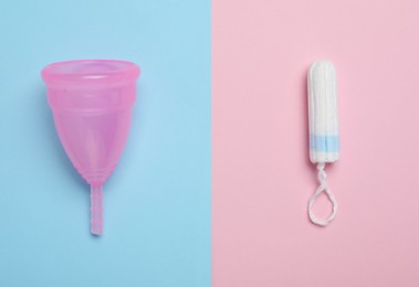 Menstrual cup and tampon on color background, flat lay