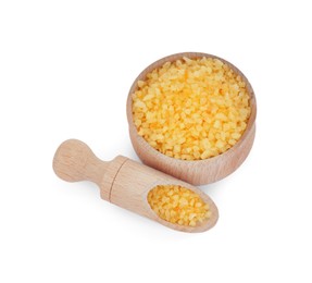 Photo of Bowl and scoop with yellow sea salt isolated on white