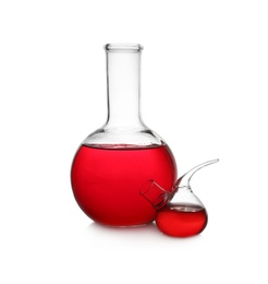 Photo of Laboratory glassware with red liquid on white background