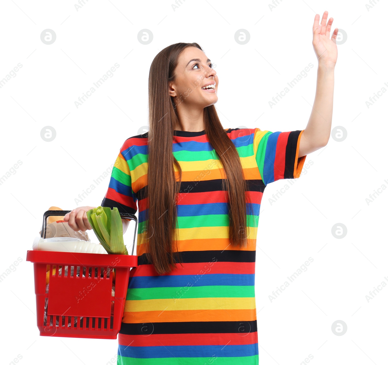 Photo of Young woman with shopping basket full of products isolated on white